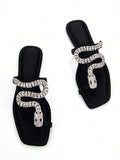 Discover the ultimate combination of elegance and comfort with our Elegantly Chic 3D Snake Crystal Chain Black Lycra Slip-On Flat Mule Sandals. Featuring a stunning 3D snake crystal chain design and a slip-on style for easy wear, these sandals are perfect for any occasion. Walk in style and comfort with our chic and trendy flats.