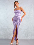 Unleash your elegance with this lilac satin halter dress featuring a high slit and backless design. Elevate your style game with a touch of playful sophistication. (2 exclamation points)