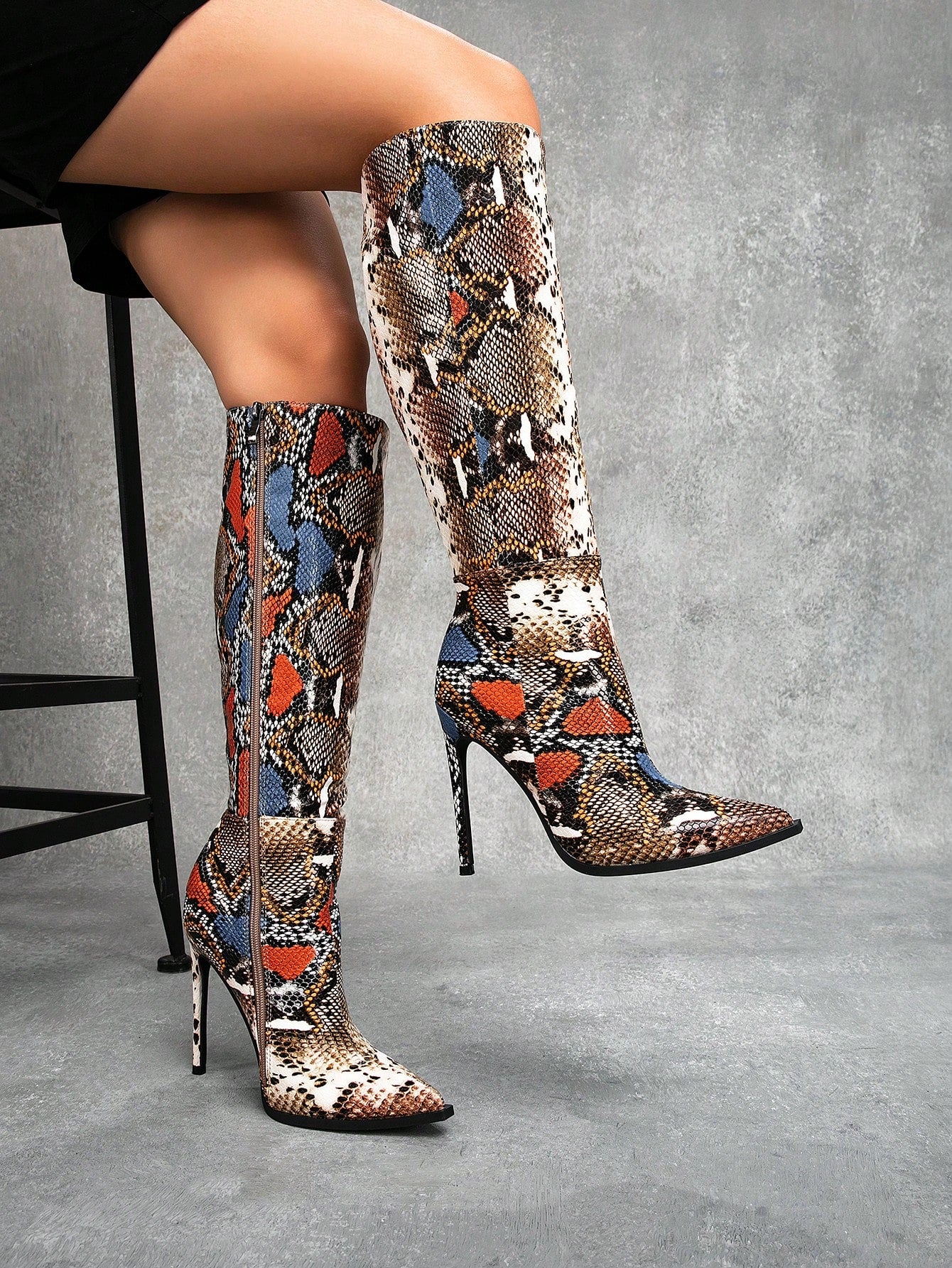 Add a playful and vibrant touch to your wardrobe with our Elevate Your Style: Colorful Snake Pattern Knee-High Stiletto Boots. These unique boots will elevate your style while making a statement with their eye-catching snake pattern. Perfect for any fashion-forward individual looking to stand out from the crowd. (No snakes were harmed in the making of these boots!)