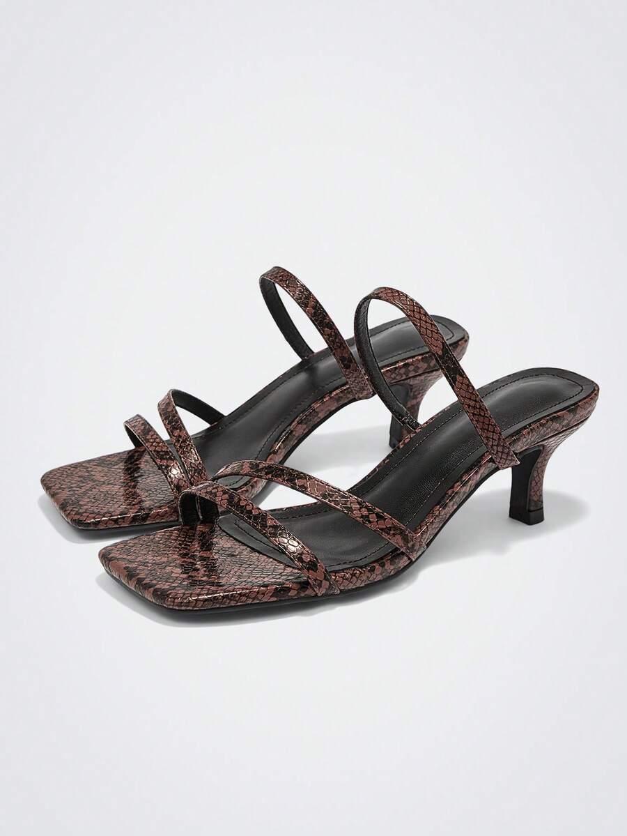 Step into sophistication with our snakeskin strapped high heel sandals—the ultimate style upgrade for any occasion. Featuring a striking snakeskin pattern and secure straps, these heels transition seamlessly from your daily commute to evening celebrations. The elevated heel adds instant glamour while the supportive design keeps you comfortable all day long. Whether you're heading to the office or dancing the night away at holiday parties, these versatile sandals deliver the perfect blend of edge and eleganc