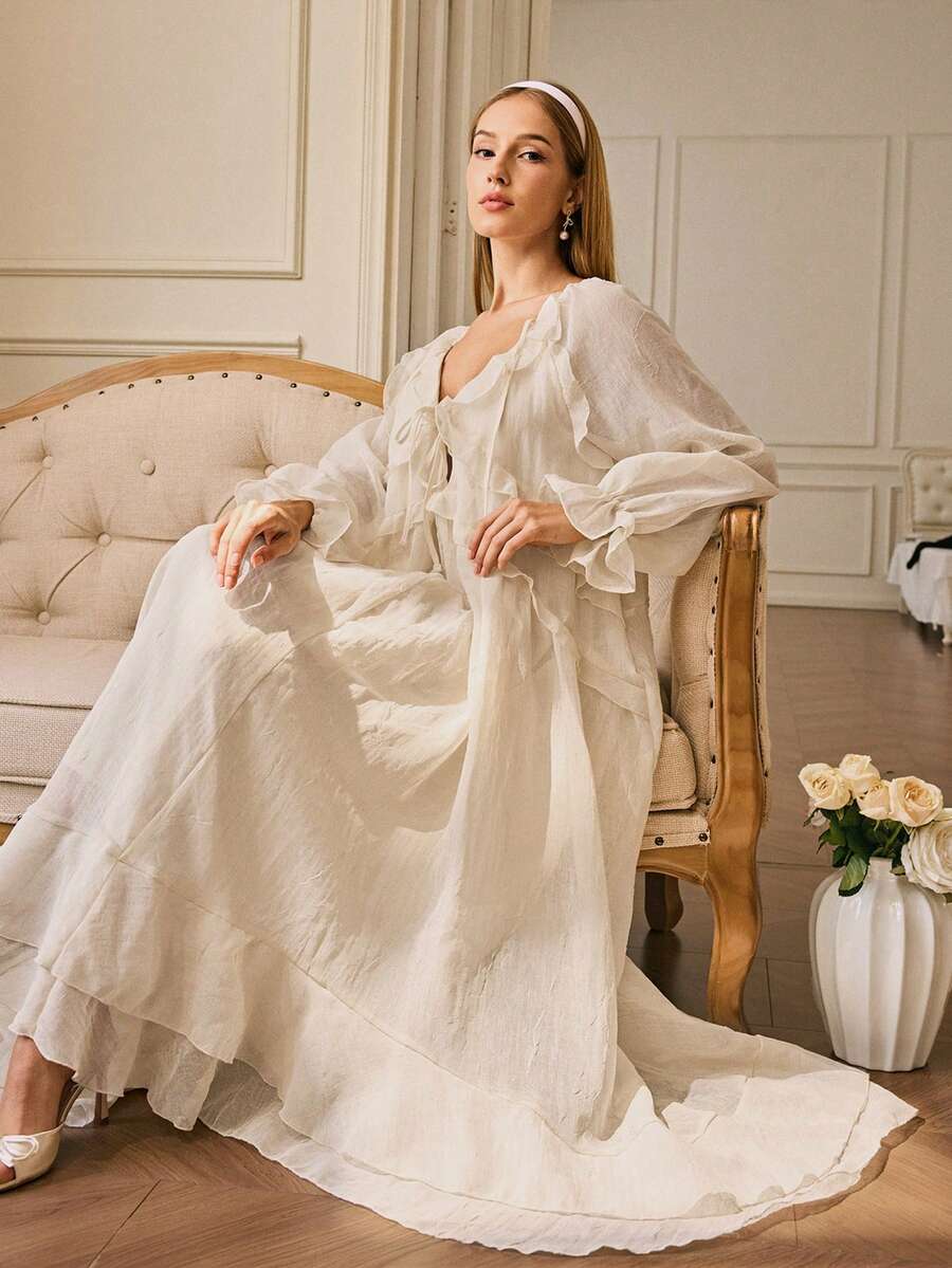 Effortlessly transition from summer vibes to autumn adventures in this stunning sheer ruffle trim long sleeve dress. The delicate ruffled edges add a touch of romantic flair, while the flowing silhouette keeps you cool and comfortable. Whether you're strolling along the beach or embracing cozy fall days, this versatile piece layers beautifully and works as a cover-up or standalone statement. Dress it up with heels for evening elegance or keep it casual with sandals for laid-back charm. A wardrobe essential 