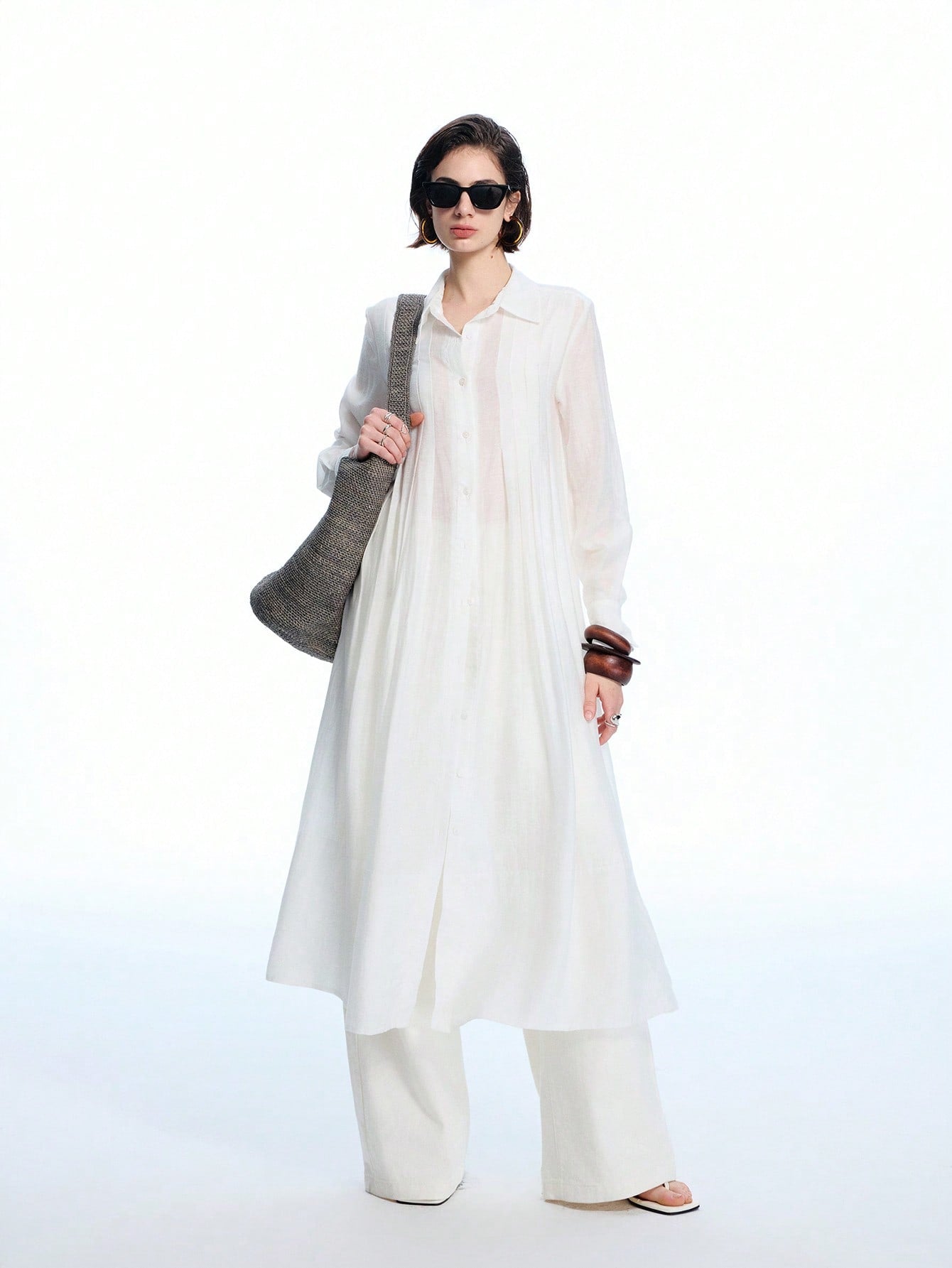 Step into effortless boho chic with this minimalist ruched white semi-sheer shirt dress. Its delicate fabric and subtle ruching create a breezy, flattering silhouette perfect for sunny days or casual nights out. Light and airy, it’s your go-to piece for adding a touch of playful elegance to any wardrobe.