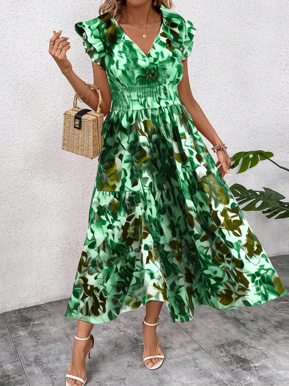 Embrace elegance and summer style with our V-neck floral maxi dress. Perfect for your next resort getaway, this dress boasts a flattering silhouette and a playful floral print. Be the envy of every fashionista in this statement piece.