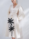 Step into sunshine with the Embroidered Palm Maxi! Featuring a flirty V-neck, breezy bell sleeves, and a playful high-low hem, this dress dances with every step. The drawstring weave belt cinches your waist just right, adding a touch of charm to your effortless style. Perfect for twirling through warm days and balmy nights!