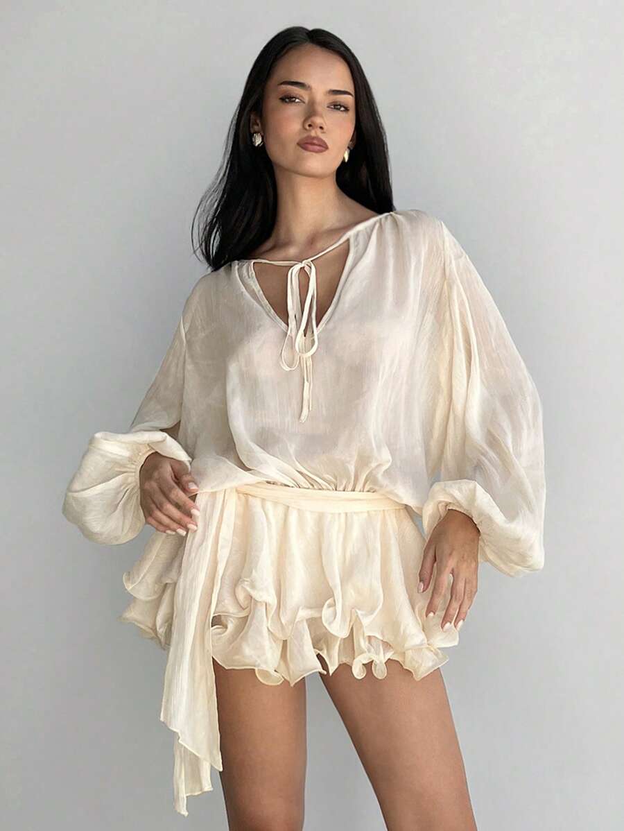 Step into a world of sparkle and charm with this glittering mini dress. Featuring whimsical lantern sleeves and a flirty ruffled hem, it’s designed to make every evening feel like a fairy tale. Perfect for twirling under the stars and turning heads wherever you go.