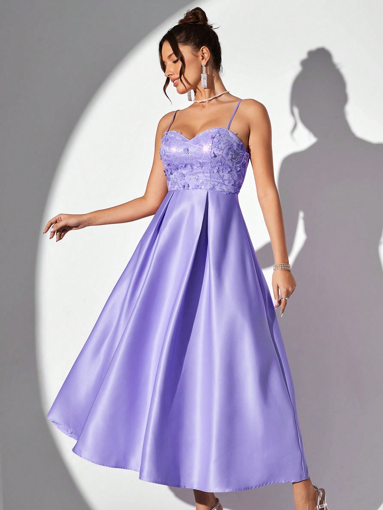 This enchanting lavender spaghetti strap evening gown exudes grace and elegance. The glittering floral accents add a touch of glamour to this timeless piece. Made with the highest quality materials, this gown is perfect for any special occasion. Style and sophistication combined in one stunning dress.