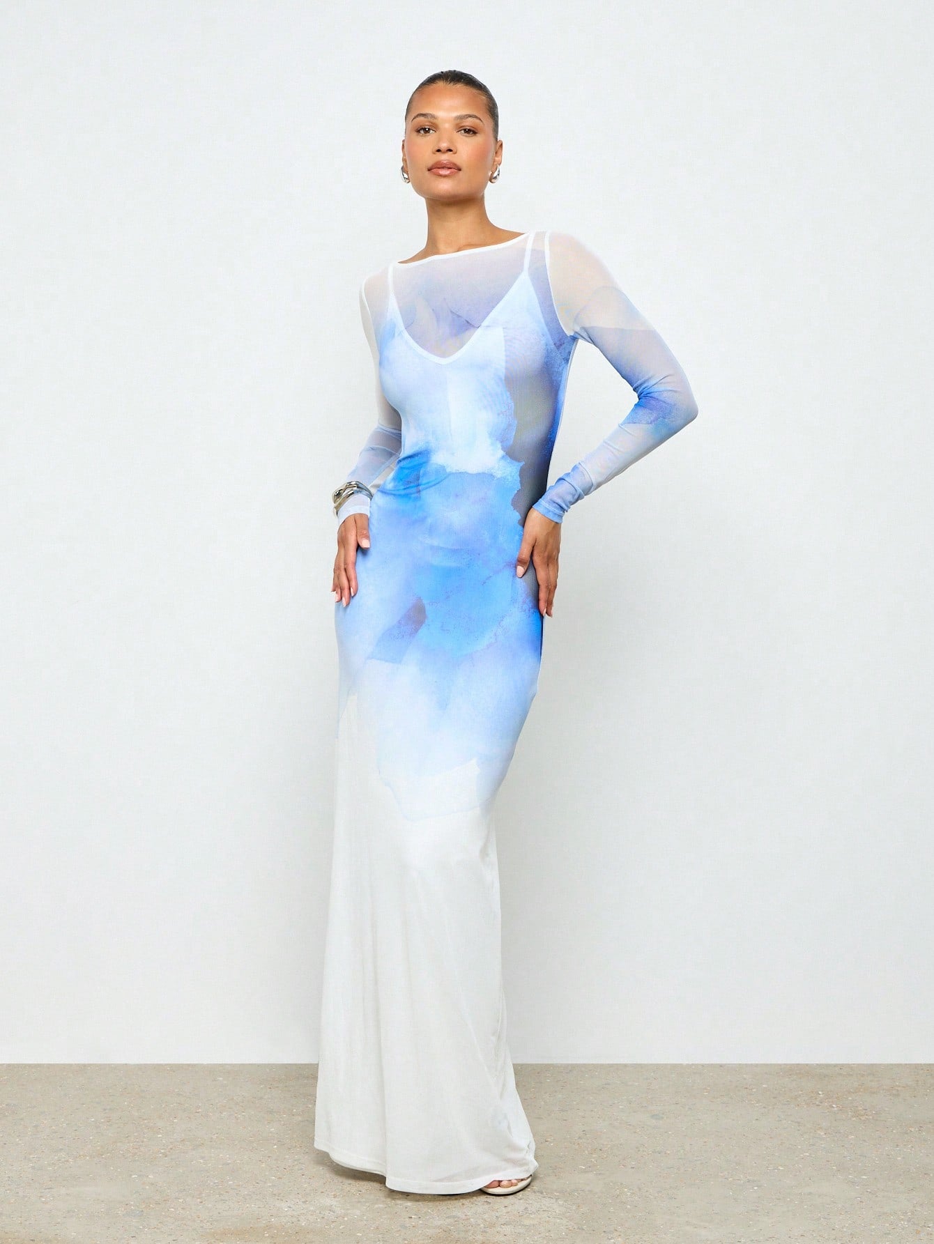 Step into a dream in this Ethereal Watercolor Maxi Dress, where soft hues blend like a watercolor painting. The long sleeve mesh overlay adds a touch of delicate whimsy, perfect for turning heads at weddings or any fancy affair. Flowing elegance meets playful charm for a look that's as unforgettable as you are.