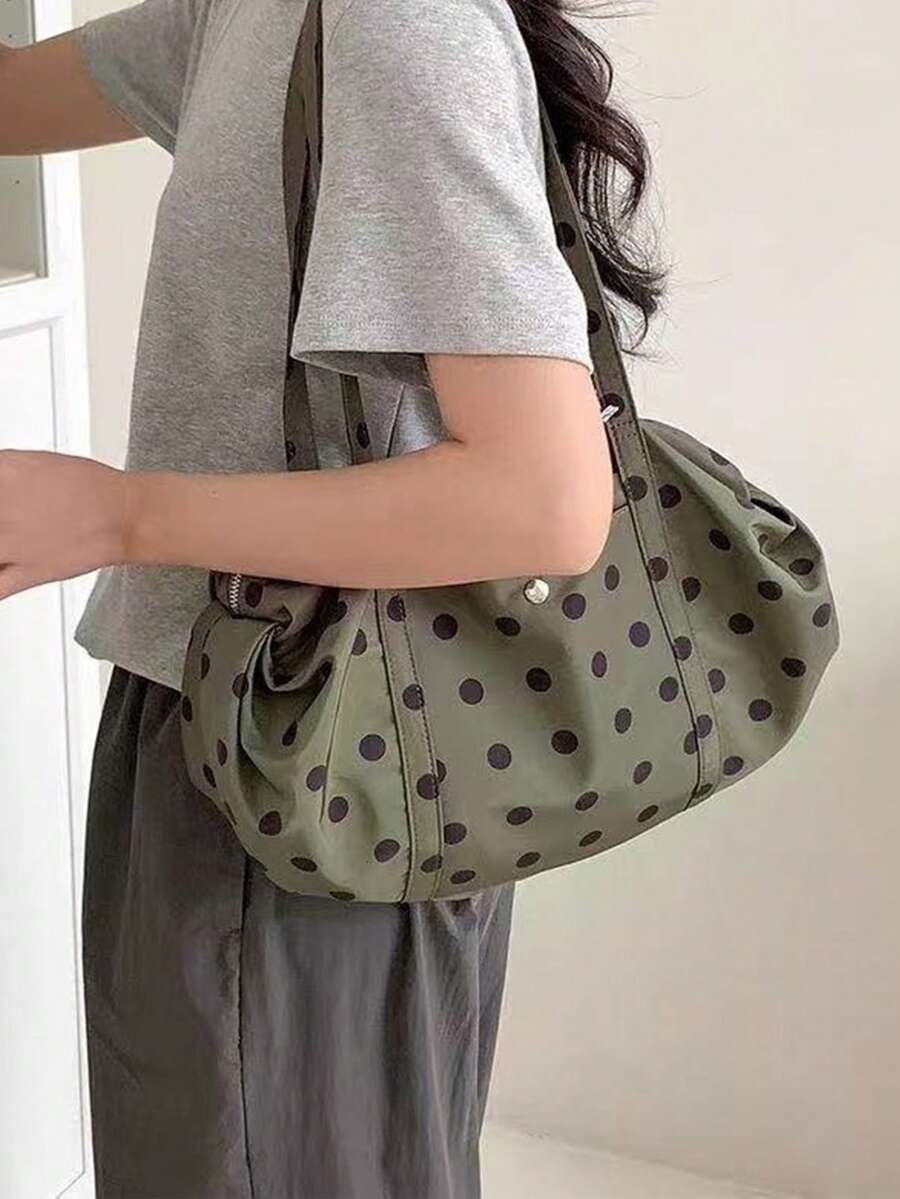 Olive green fabric shoulder tote bag with black polka dots long straps soft gathered sides worn on shoulder