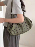 Olive green fabric shoulder tote bag with black polka dots long straps soft gathered sides worn on shoulder