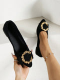Handheld close-up and on-foot view of black pointed-toe flats with gold jeweled vamp ornament