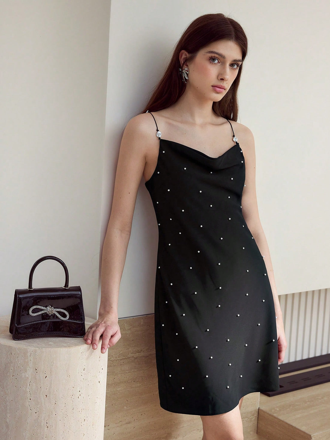 Step into charm with the Faux Pearl Decor Cami Dress, where delicate pearl accents meet a flirty silhouette. Perfect for turning heads at brunch or dancing the night away, this dress adds a playful touch of elegance to any occasion. Feel effortlessly chic and ready to sparkle wherever you go!