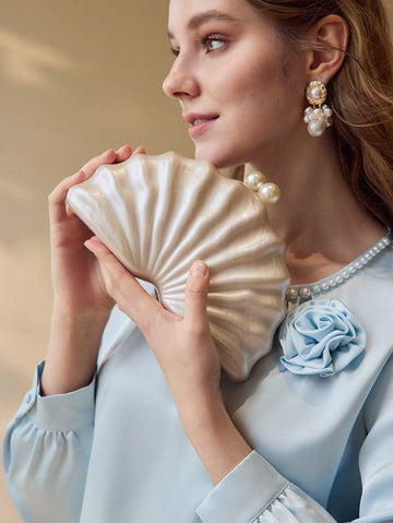 Elevate your special occasion style with this faux pearl kiss lock clutch for women. Featuring a timeless pearl-inspired finish and a classic kiss lock closure, this elegant evening bag is designed to add sophistication to weddings, proms, cocktail parties, and formal celebrations.