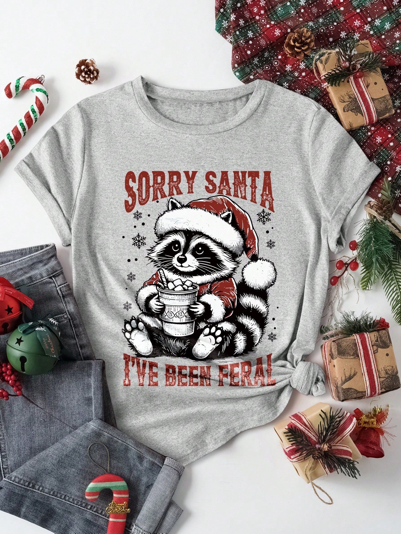 Celebrate the holidays in style with our Festive Raccoon Graphic Tee. Expertly designed for women, this tee features a playful raccoon graphic that adds a touch of festive charm. Made from high-quality materials, it's the perfect gift for any holiday lover.
