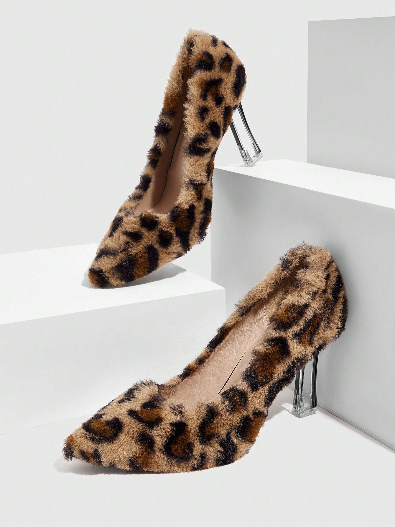 Add some sass to your step with our Fierce Elegance high heels. Featuring a bold leopard print and sparkling crystal accents, these pointed toe heels are perfect for making a statement. Strut your stuff with style and confidence.
