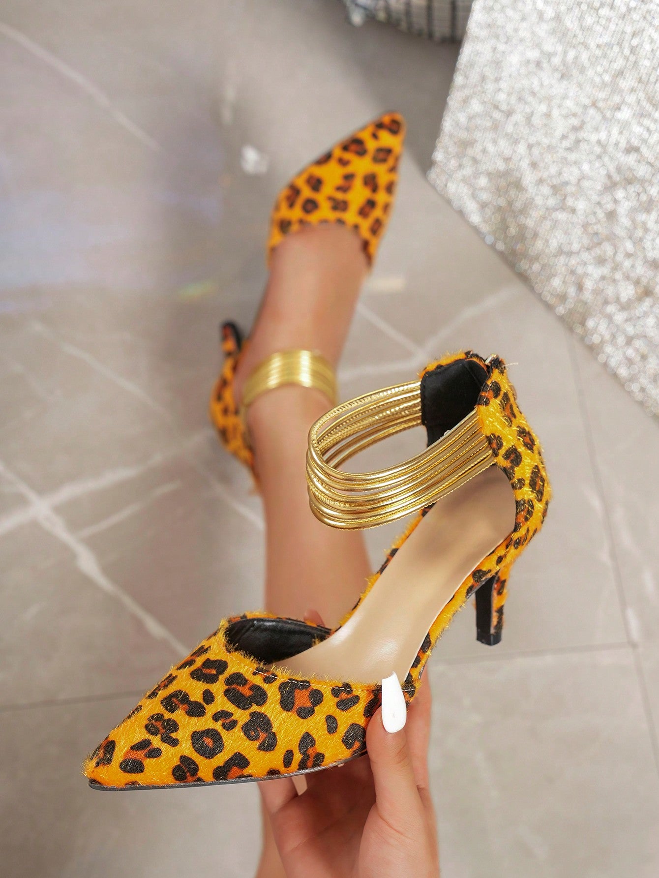 Discover the perfect balance of fierce and elegant with our Pointed Toe Leopard Print High Heels. The sleek, pointed toe design exudes confidence, while the stylish leopard print adds a touch of boldness. Accented with gold straps for a touch of glamour. Elevate any outfit with these statement heels.