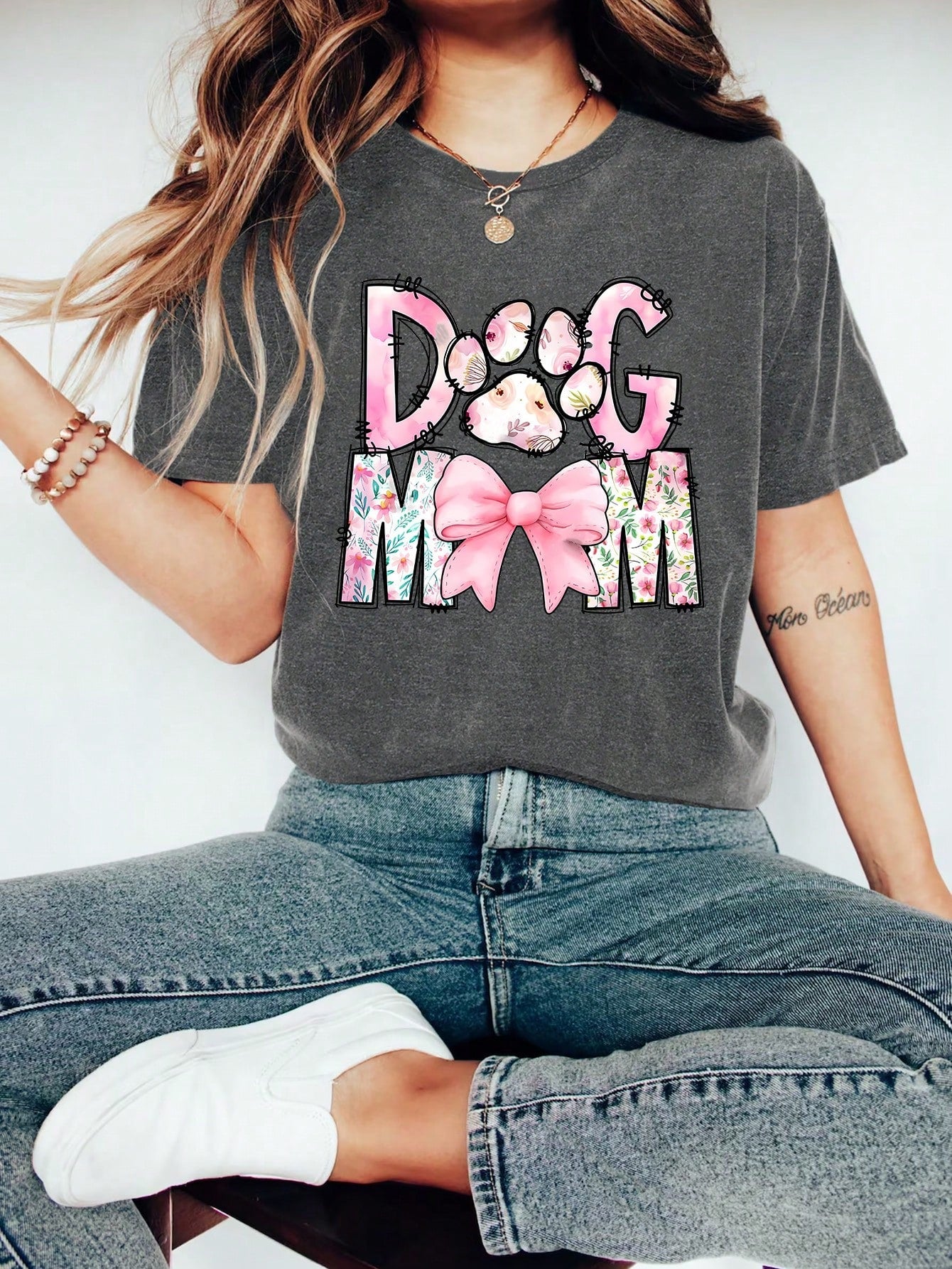 Unleash your love for your furry best friend with our Floral Cartoon 'Dog Mom' Graphic Tee! Perfect for dog lovers, this cute and casual summer top features a fun floral cartoon design and playfully proclaims your status as a proud 'dog mom'. Get yours today and wear it with pride!