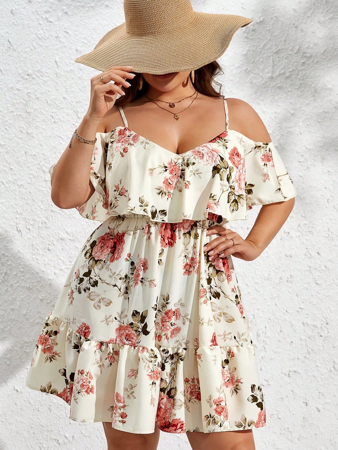 Add a touch of elegance with this floral plus size cold shoulder dress. The ruffle hem detail adds a charming touch while the cold shoulder design keeps you cool and trendy. Perfect for any occasion, this dress will have you feeling confident and stylish.