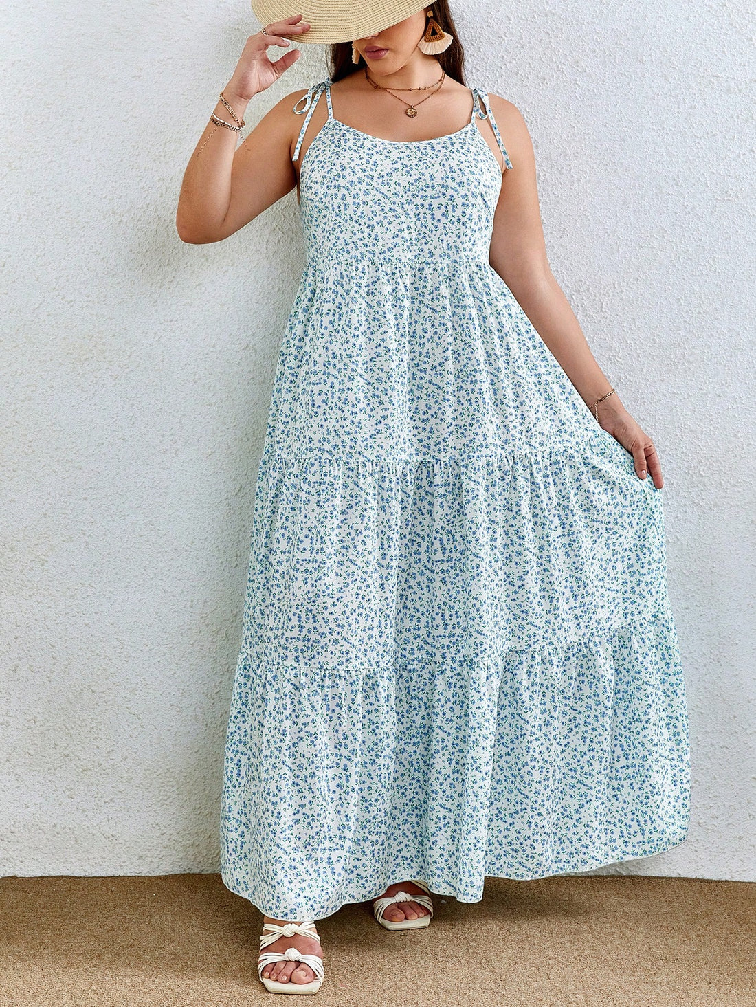 Add a touch of whimsy to your wardrobe with the Floral Elegance: Plus Size Ditsy Print Tie Shoulder Ruffle Hem Cami Dress. The delicate ditsy print and playful ruffle hem bring a sense of charm and elegance to this cami dress. The tie shoulder detail adds a unique touch to this flowy and flattering plus size dress.