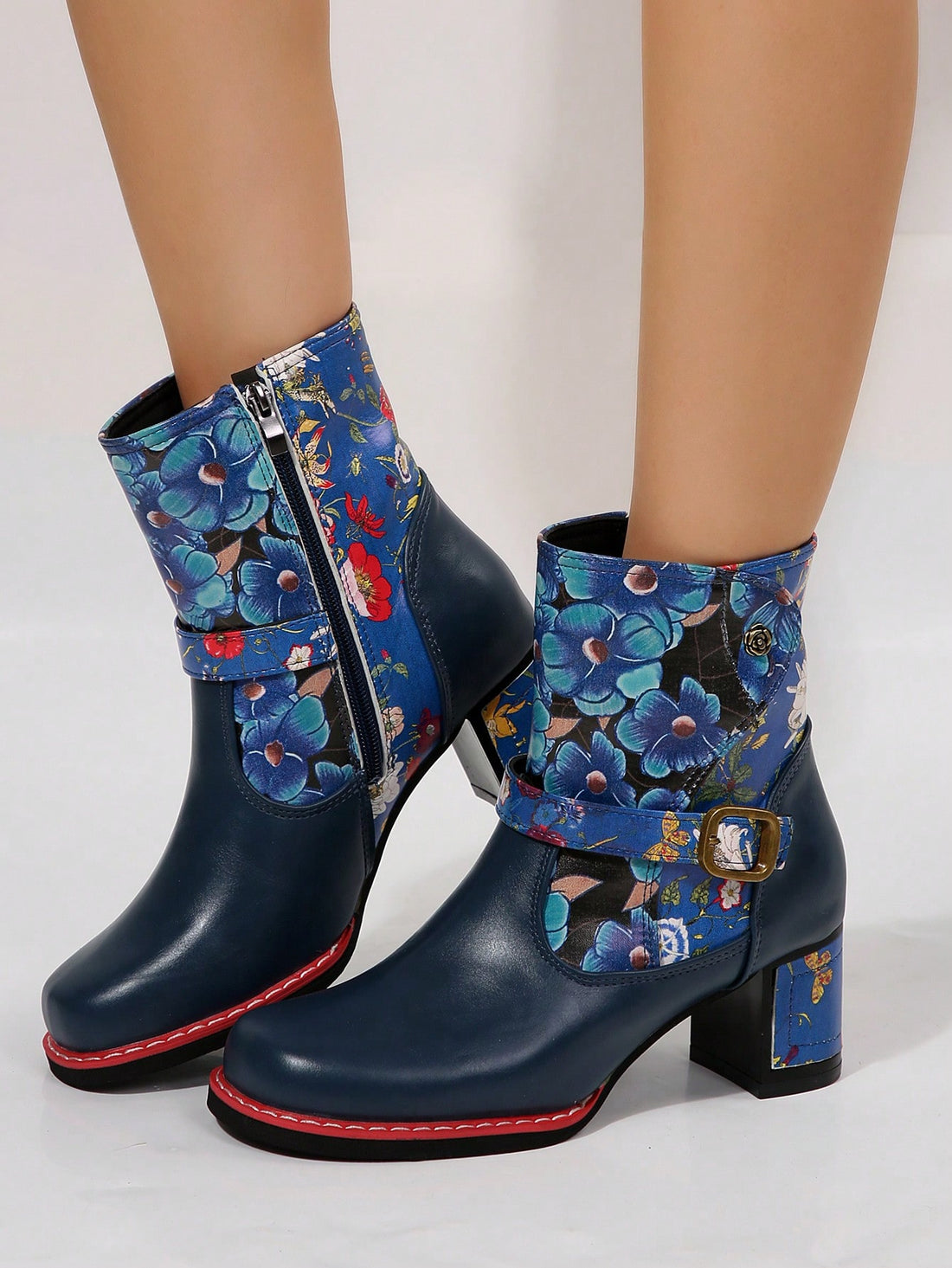 Step up your western style game with these Floral Patterned Western Ankle Boots. The chunky heel provides stability and comfort, while the side zipper allows for easy on and off. The eye-catching floral pattern adds a touch of femininity to this classic cowboy boot design. Elevate any outfit with these versatile and stylish boots.