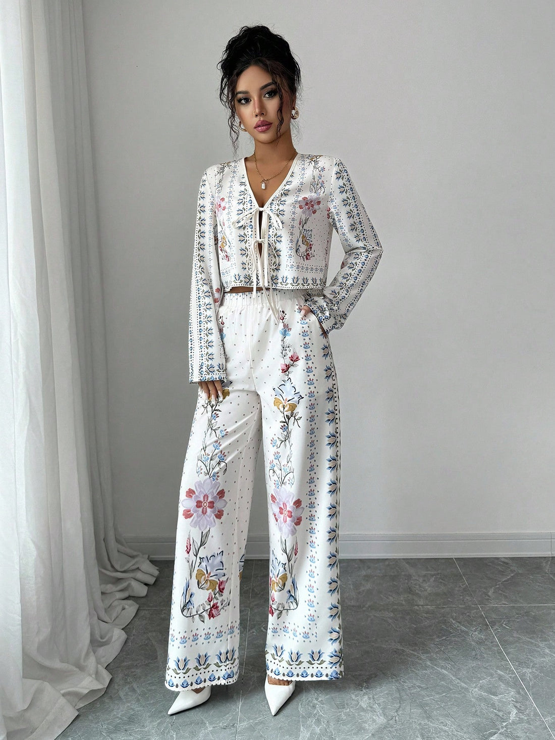 Bloom into autumn with this charming two-piece ensemble that pairs a vibrant floral long-sleeve shirt with coordinating pants. Perfect for fall getaways, this casual suit strikes the ideal balance between comfort and style—no fussy dressing required. The relaxed fit lets you move freely while exploring new destinations, and the botanical print adds a cheerful pop of personality to your travel wardrobe. Whether you're strolling through pumpkin patches or enjoying cozy café moments, this set keeps you looking