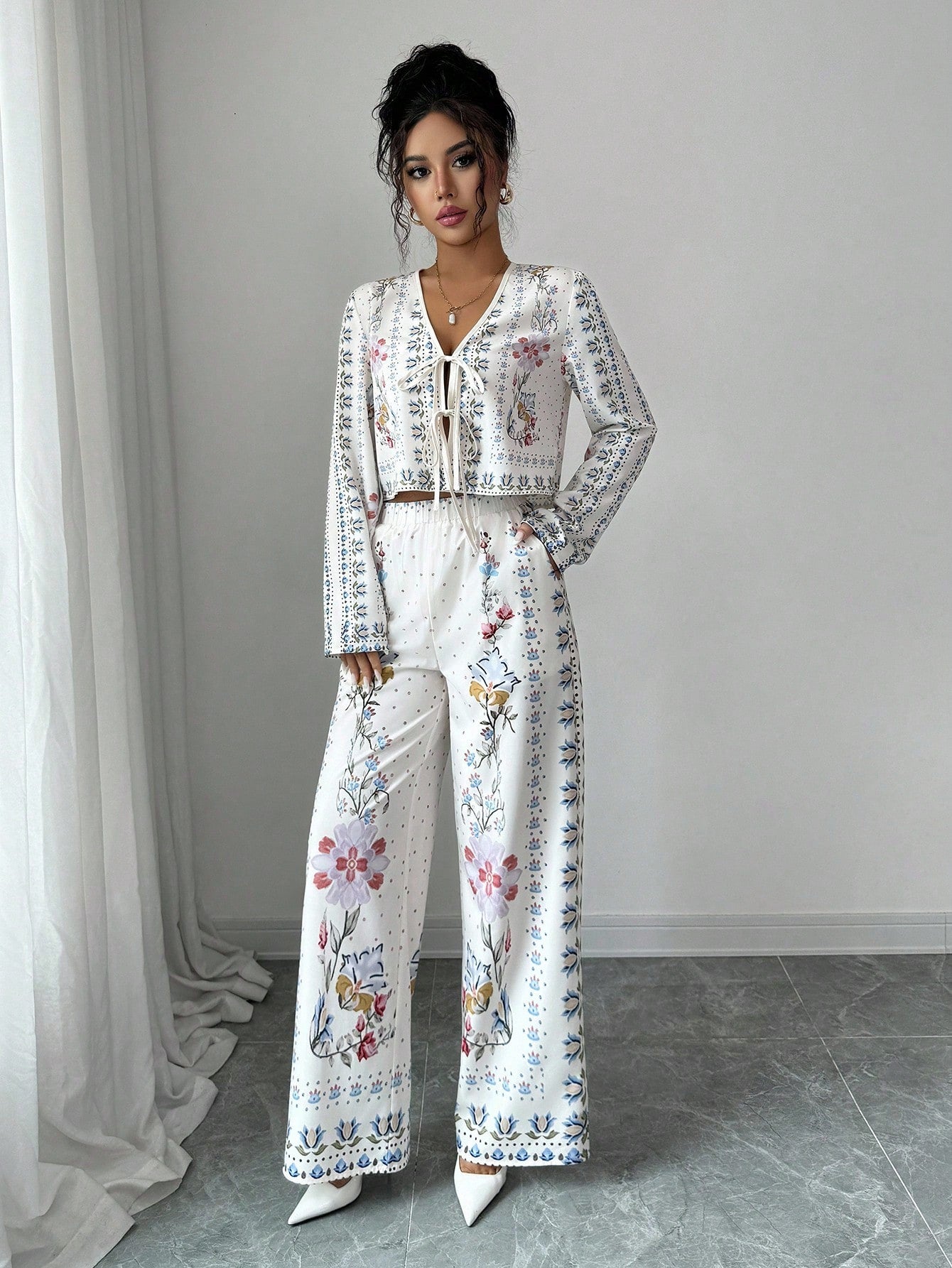 Bloom into autumn with this charming two-piece ensemble that pairs a vibrant floral long-sleeve shirt with coordinating pants. Perfect for fall getaways, this casual suit strikes the ideal balance between comfort and style—no fussy dressing required. The relaxed fit lets you move freely while exploring new destinations, and the botanical print adds a cheerful pop of personality to your travel wardrobe. Whether you're strolling through pumpkin patches or enjoying cozy café moments, this set keeps you looking