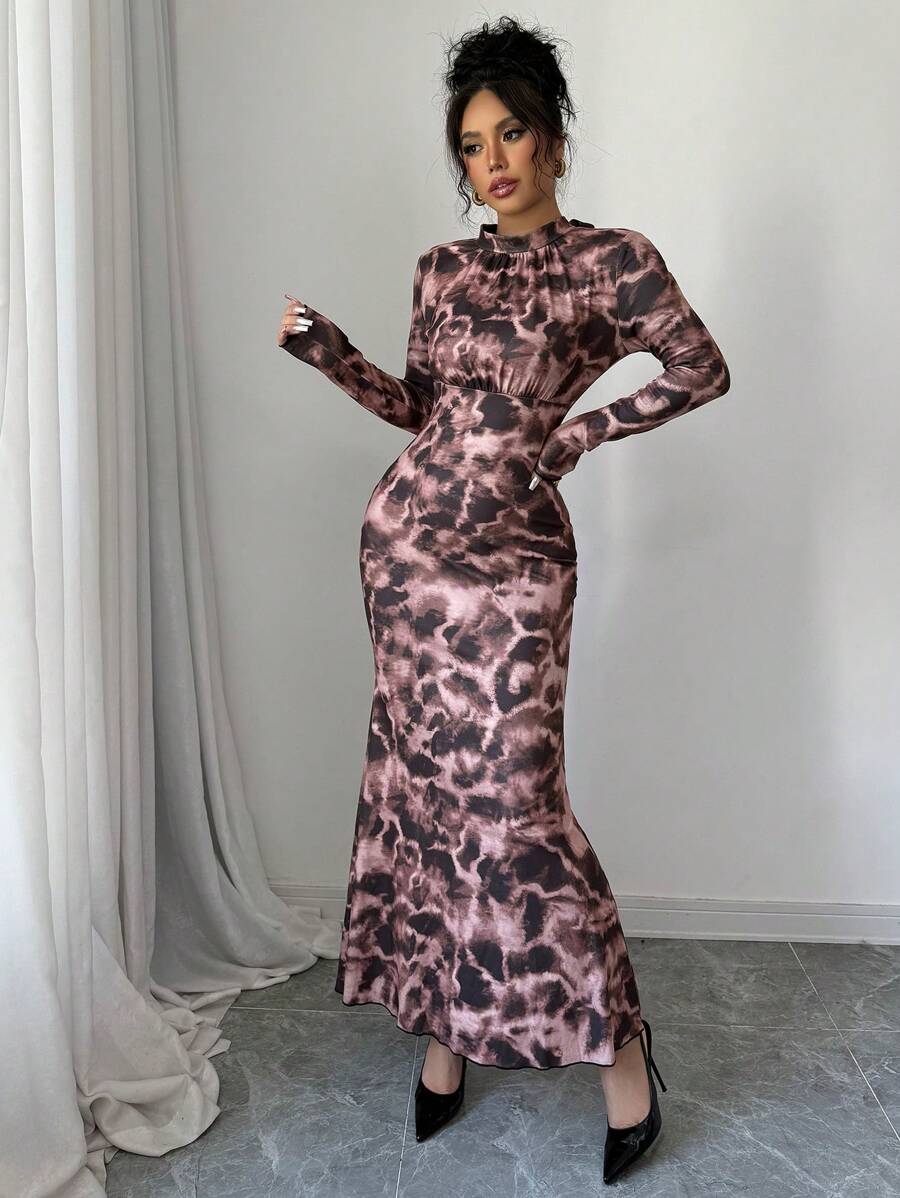 Elevate your fall evening wardrobe with this stunning floral print high-neck fishtail maxi dress. Crafted from a luxurious knitted fabric blend of 93% polyester and 7% elastane, this dress offers medium stretch comfort without compromising on elegance. The sophisticated design features a high round neckline, long sleeves, and a flattering slim-fit silhouette that hugs your curves beautifully. The signature mermaid hem with ruffle detailing and strategic ruching creates a dramatic.
