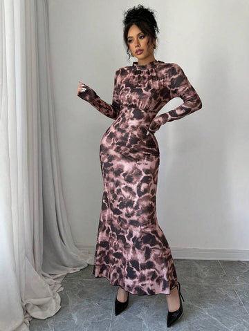 Elevate your fall evening wardrobe with this stunning floral print high-neck fishtail maxi dress. Crafted from a luxurious knitted fabric blend of 93% polyester and 7% elastane, this dress offers medium stretch comfort without compromising on elegance. The sophisticated design features a high round neckline, long sleeves, and a flattering slim-fit silhouette that hugs your curves beautifully. The signature mermaid hem with ruffle detailing and strategic ruching creates a dramatic.