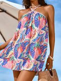 Front close-up of blue pink tropical floral mini swing dress at the beach