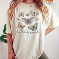 This Fluttering Beauty: Butterfly Print T-shirt brings a touch of nature to your wardrobe. The delicate butterfly print is perfect for any occasion, while the short sleeves provide comfort and style. Made for women who appreciate the beauty of nature, this T-shirt is a must-have addition to your collection.