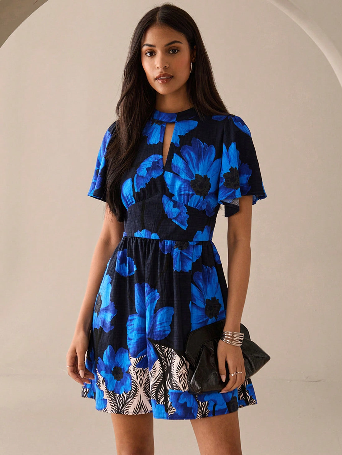 Step out in style with this playful blue mini dress featuring a charming full floral print and a flirty keyhole neckline. Its short sleeves keep it breezy and perfect for urban adventures or romantic evenings. Lightweight and fun, it’s your go-to for turning heads wherever you go.