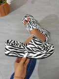 Step up your shoe game with our Funky Zebra Print Platform Wedge Slippers. These stylish slippers feature a bold zebra print that will make a statement wherever you go. With a comfortable platform wedge, you can add height while staying comfortably stylish. A must-have addition to your shoe collection.