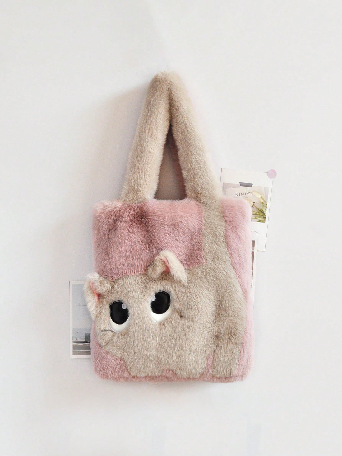 Get ready for compliments galore with our chic and playful plush cat tote bag! Made with luxurious faux fur and embroidered colorblock design, this handbag is both stylish and practical. The magnetic closure keeps your belongings secure while the adorable cat face adds a touch of fun to any outfit.