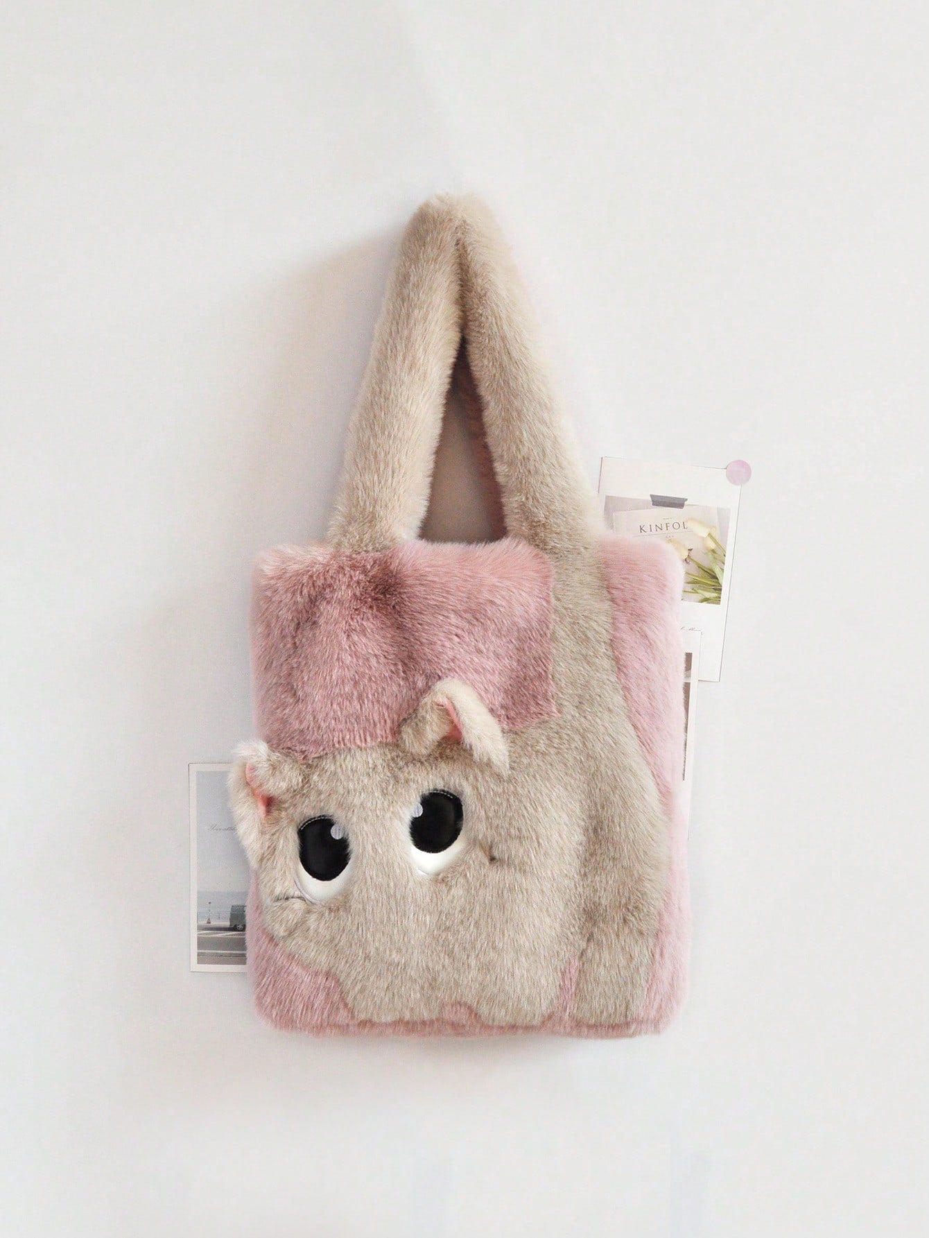 Get ready for compliments galore with our chic and playful plush cat tote bag! Made with luxurious faux fur and embroidered colorblock design, this handbag is both stylish and practical. The magnetic closure keeps your belongings secure while the adorable cat face adds a touch of fun to any outfit.