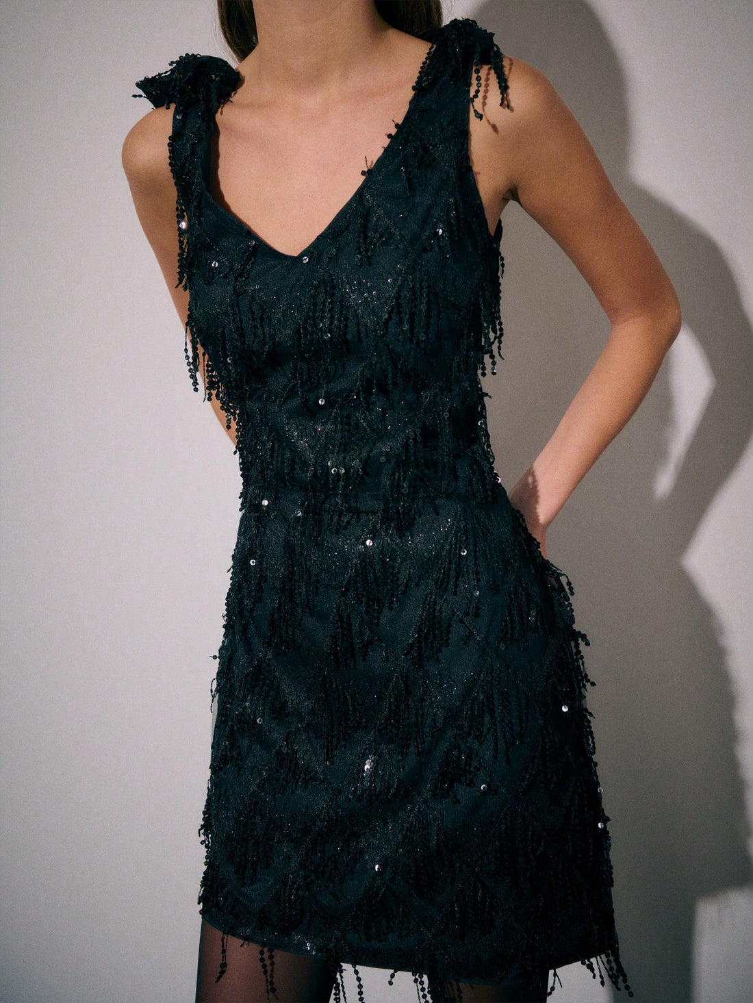 Slip into the spotlight with this show-stopping black sequin mini dress that's pure party magic. Covered in shimmering sequins from top to bottom, it catches every light on the dance floor while playful beaded tassels add movement and sass to every step. The flattering mini silhouette is cut for confidence—whether you're hitting the cocktail circuit, dancing till dawn at the club, or stealing the show at holiday celebrations. This is the dress that makes you feel like the best version of yourself. Pair it w