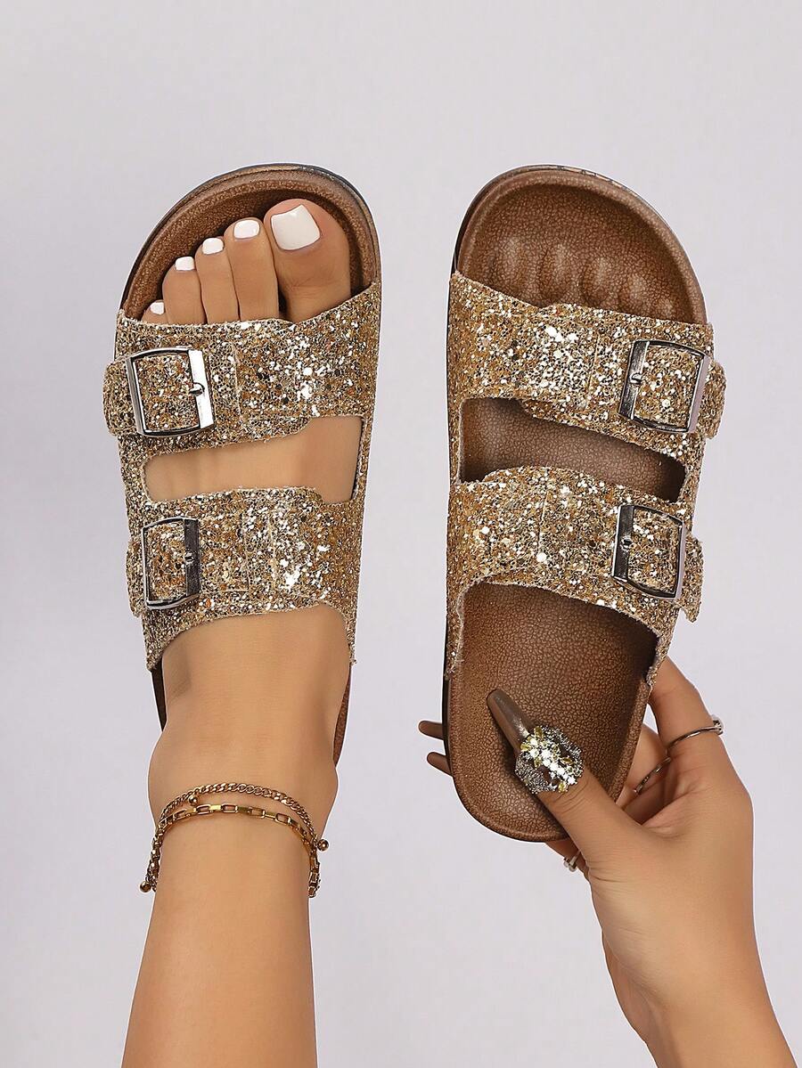Step into effortless elegance with these glamorous double-buckle flat slippers. Crafted with shimmering glitter detailing, they deliver a touch of sparkle to your everyday look. The lightweight design makes them perfect for both indoor comfort and outdoor adventures, while the adjustable buckle straps ensure a secure, customizable fit. Ideal for spring and summer, these versatile sandals transition seamlessly from lounging at home to casual outings. 
