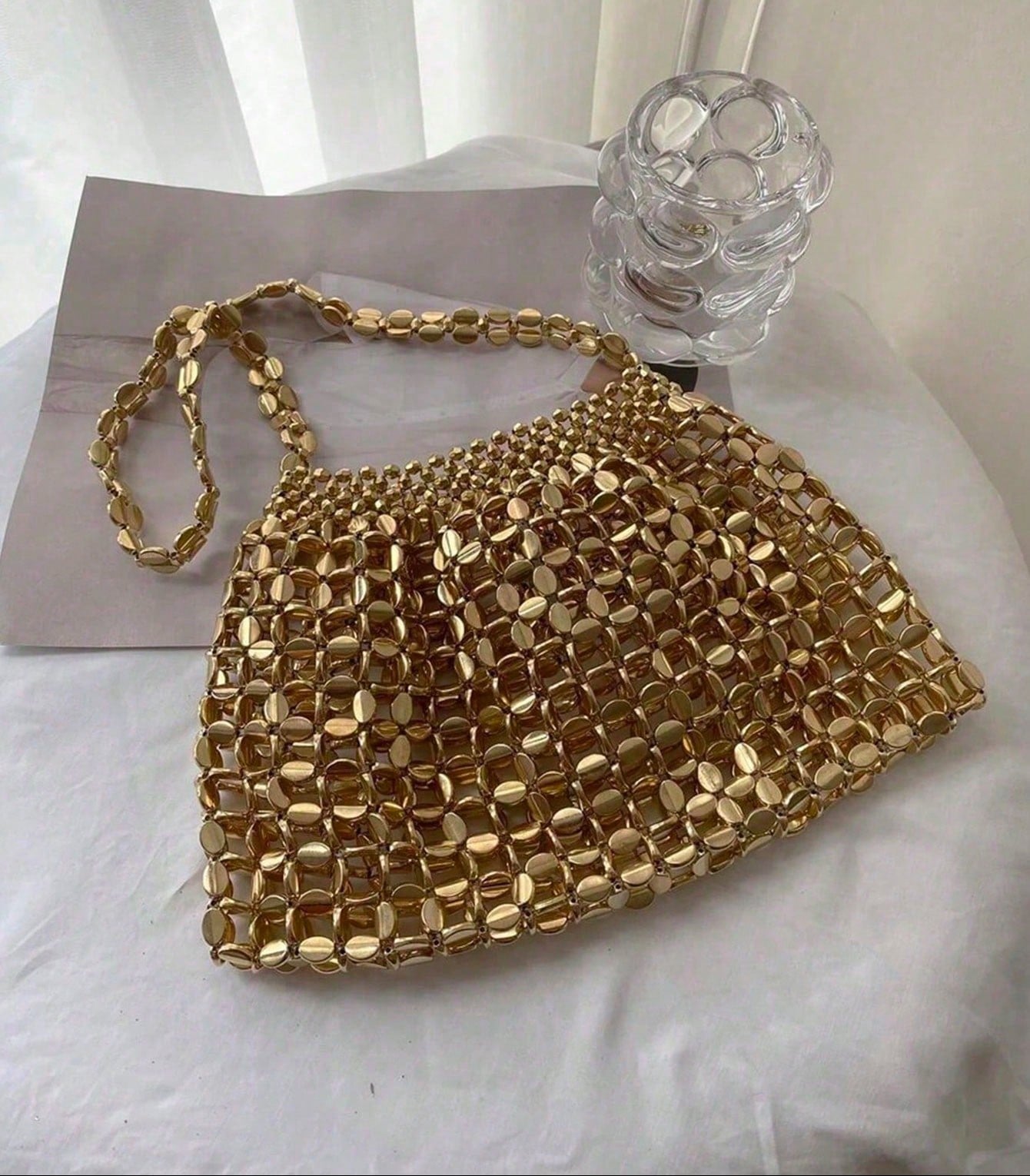 Add a splash of sparkle to your night with this Glamorous Gold Sequin Evening Bag. Perfectly sized to hold your essentials, it dazzles at parties, weddings, and prom, making you the center of attention. Its shimmering gold sequins catch the light beautifully, adding a playful touch of luxury to any outfit. Get ready to shine and make every moment unforgettable!