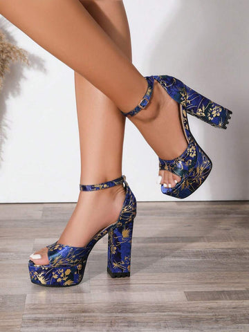 Model wearing navy blue floral platform block heels with ankle straps