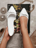 Beige pointed toe slip on flats shown on foot
