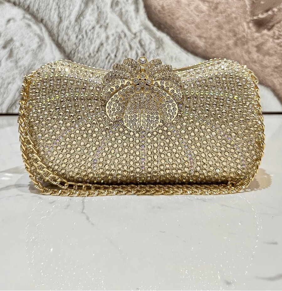 Add a pop of sparkle to your outfit with this Glamorous Rhinestone Rainbow Clutch Bag. Perfect for weddings or fancy nights out, its dazzling rhinestones catch the light beautifully while the rainbow hues keep things fun and lively. The crossbody design lets you dance the night away hands-free, making it a stylish and practical choice for your next special event.