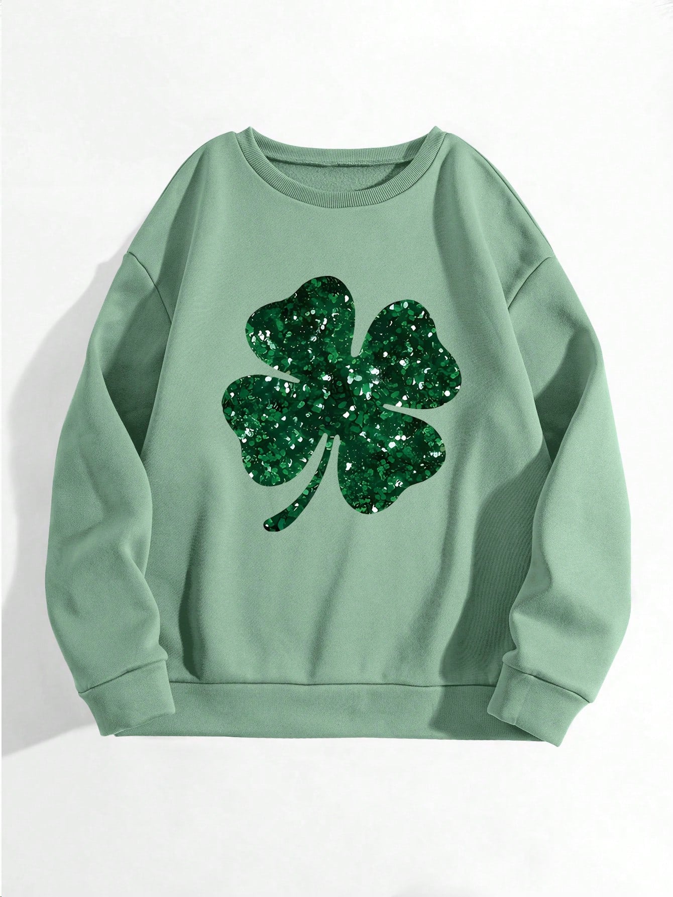 Add some sparkle and luck to your wardrobe with our Glittering Four-Leaf Clover Sweatshirt! Perfect for St. Patrick's Day celebrations or any cool weather day, this comfy hoodie will keep you cozy while also making a statement. Shine bright and stand out from the crowd with our stylish and playful sweatshirt.