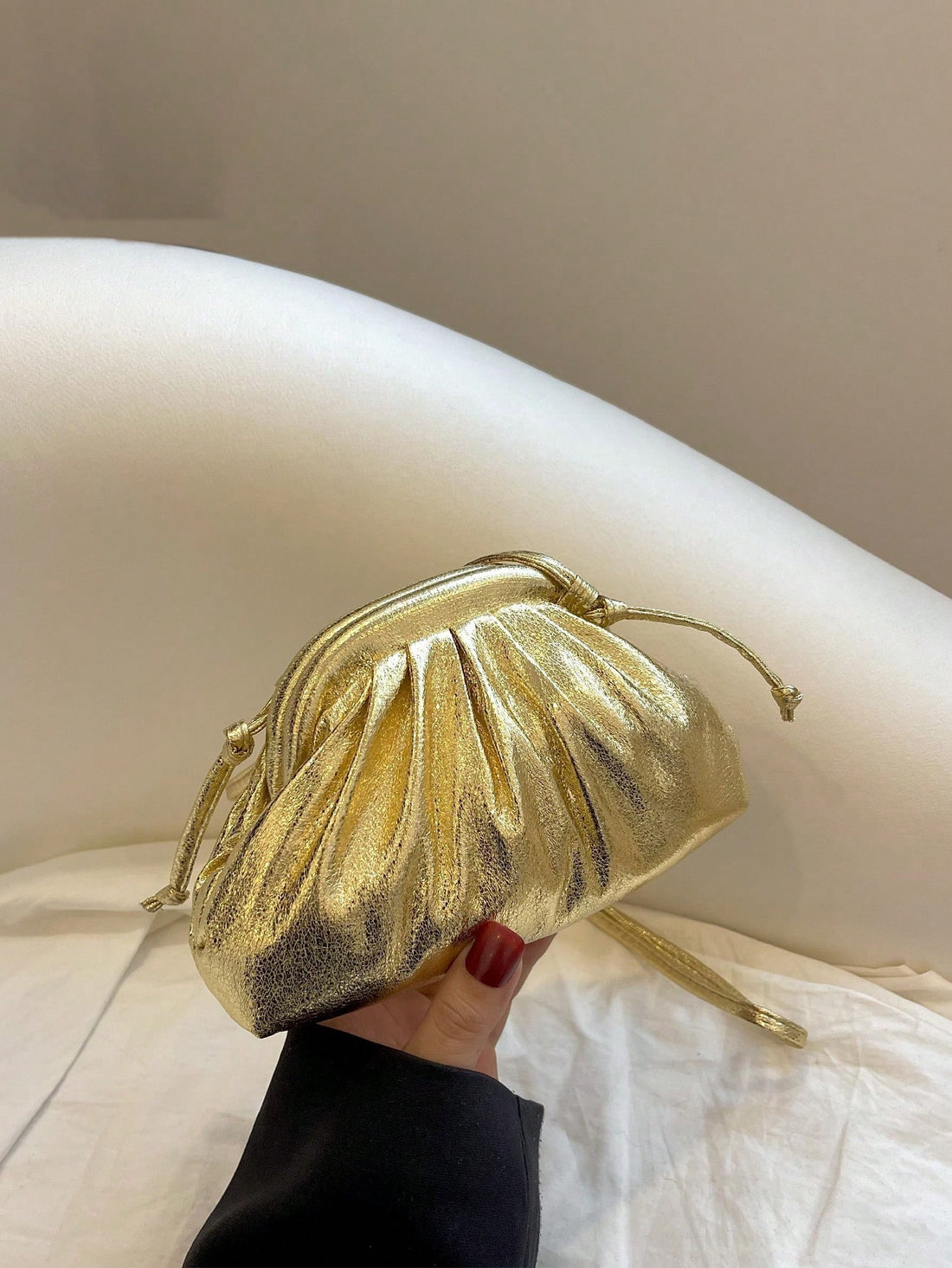 Be the ultimate funky punk with our Golden Metallic Mini Ruched Bag. Its unique design adds a touch of streetwear flair to any outfit. The ruched texture and metallic finish make it a standout accessory, perfect for making a bold statement. 