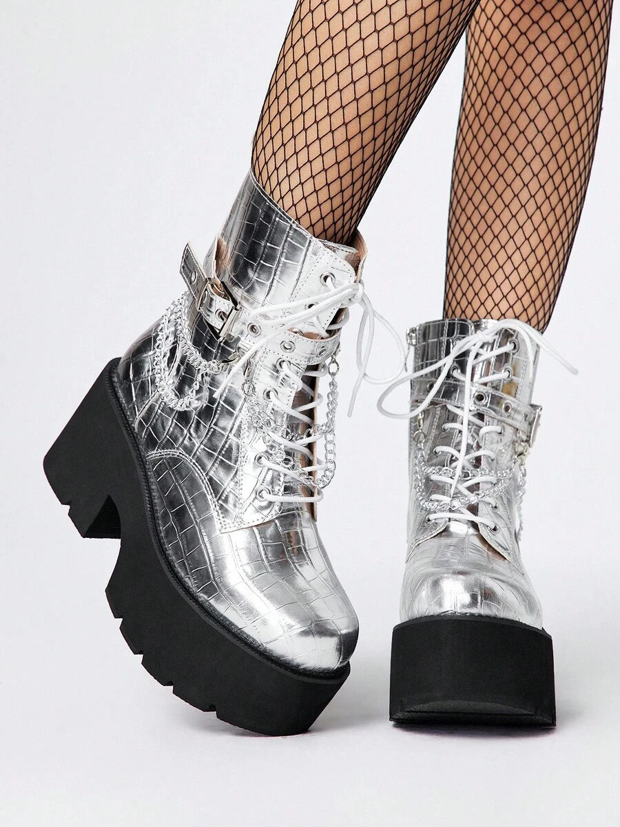 Step into bold style with these Gothic Grunge Punk Chunky Heel Ankle Boots, where edgy attitude meets everyday wearability. Featuring a sturdy platform wedge and metal chain accents, these combat-inspired boots deliver serious attitude without sacrificing comfort. The chunky heel provides stability while the padded construction keeps your feet happy through long days of making a statement. Perfect for anyone ready to embrace their darker, more rebellious side—whether you're channeling grunge vibes or full-o