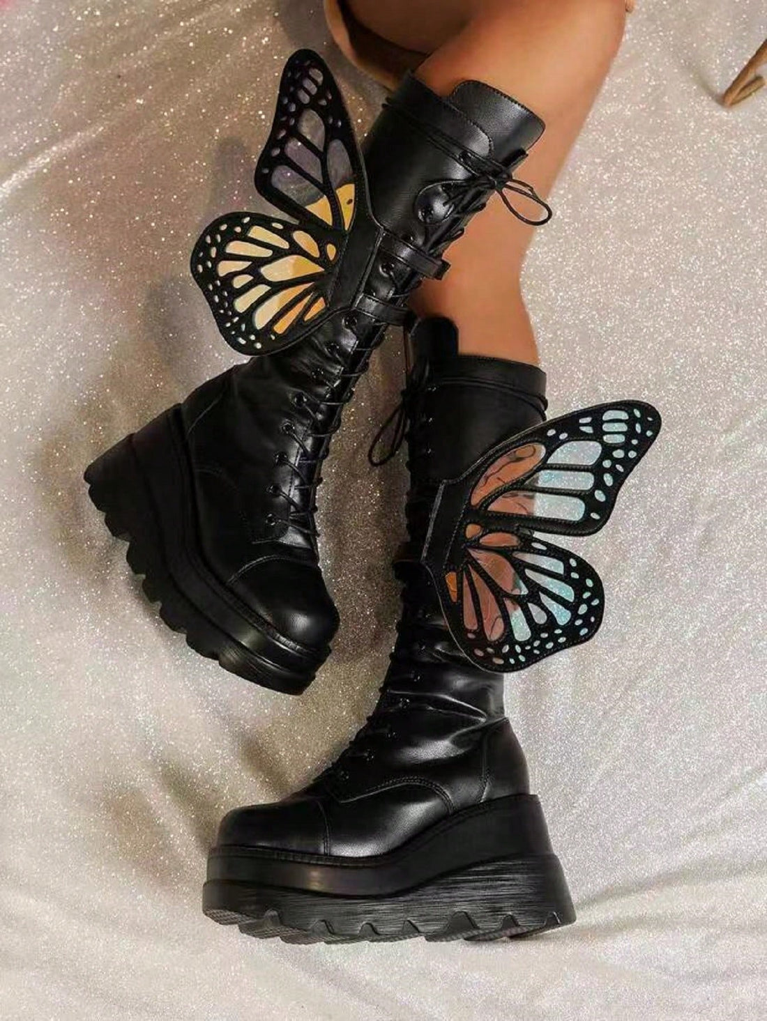 Step into edgy style with these Gothic Punk Platform Boots! The glossy butterfly decor adds a touch of whimsy, while the thick soles provide both fashion and function. Perfect for making a statement and strutting your stuff in comfort.