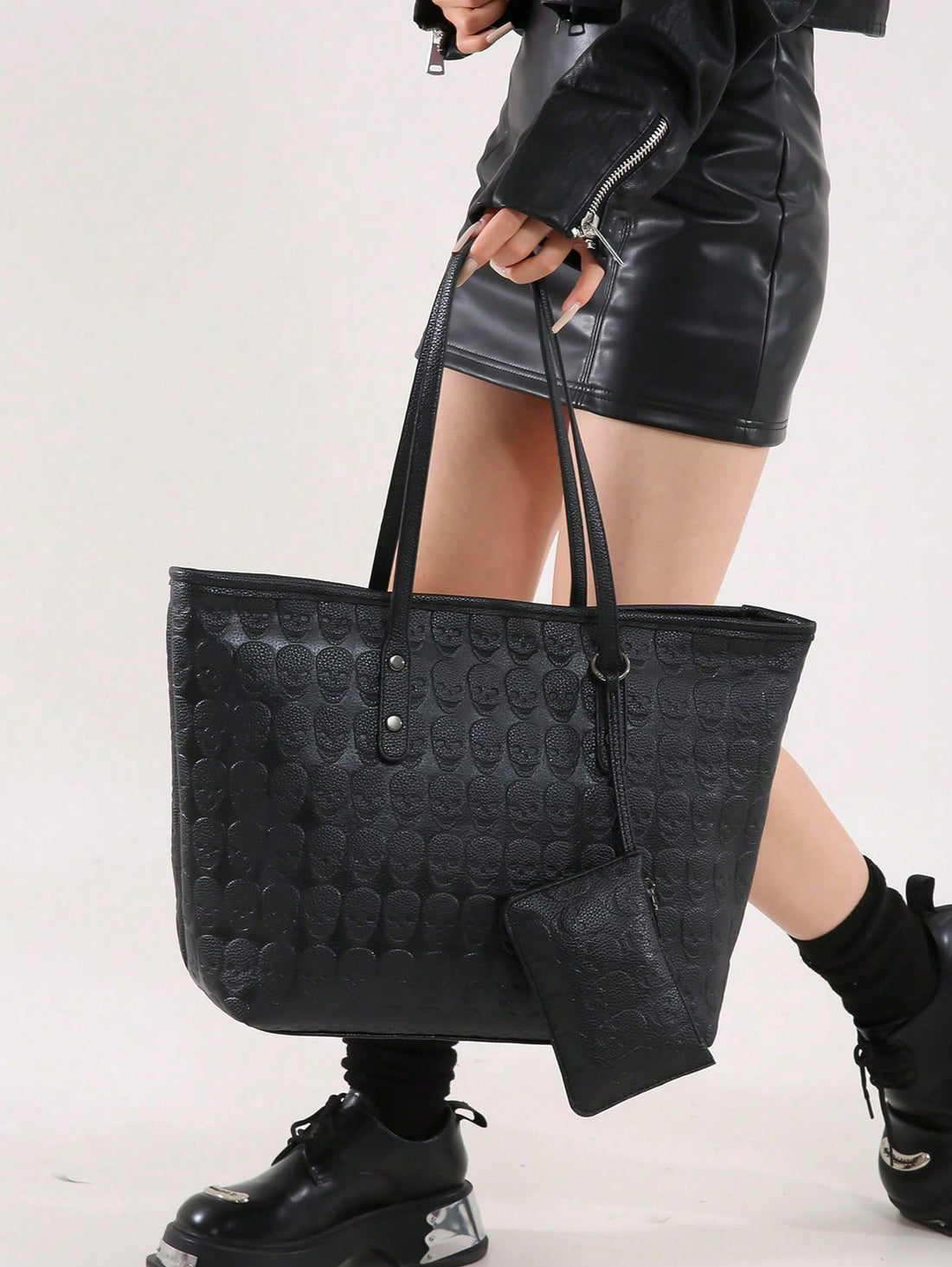 This Gothic Skull Print Tote Bag is a must-have for any stylish woman. With its trendy design and high-quality construction, it's perfect for everyday use. The gothic skull print adds a unique touch, while the spacious interior and sturdy handles make it a practical choice for carrying all your essentials. Elevate your look with this fashionable and functional tote bag.