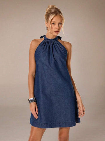 Close front view of deep-blue halter mini dress showing gathered neckline and swing silhouette