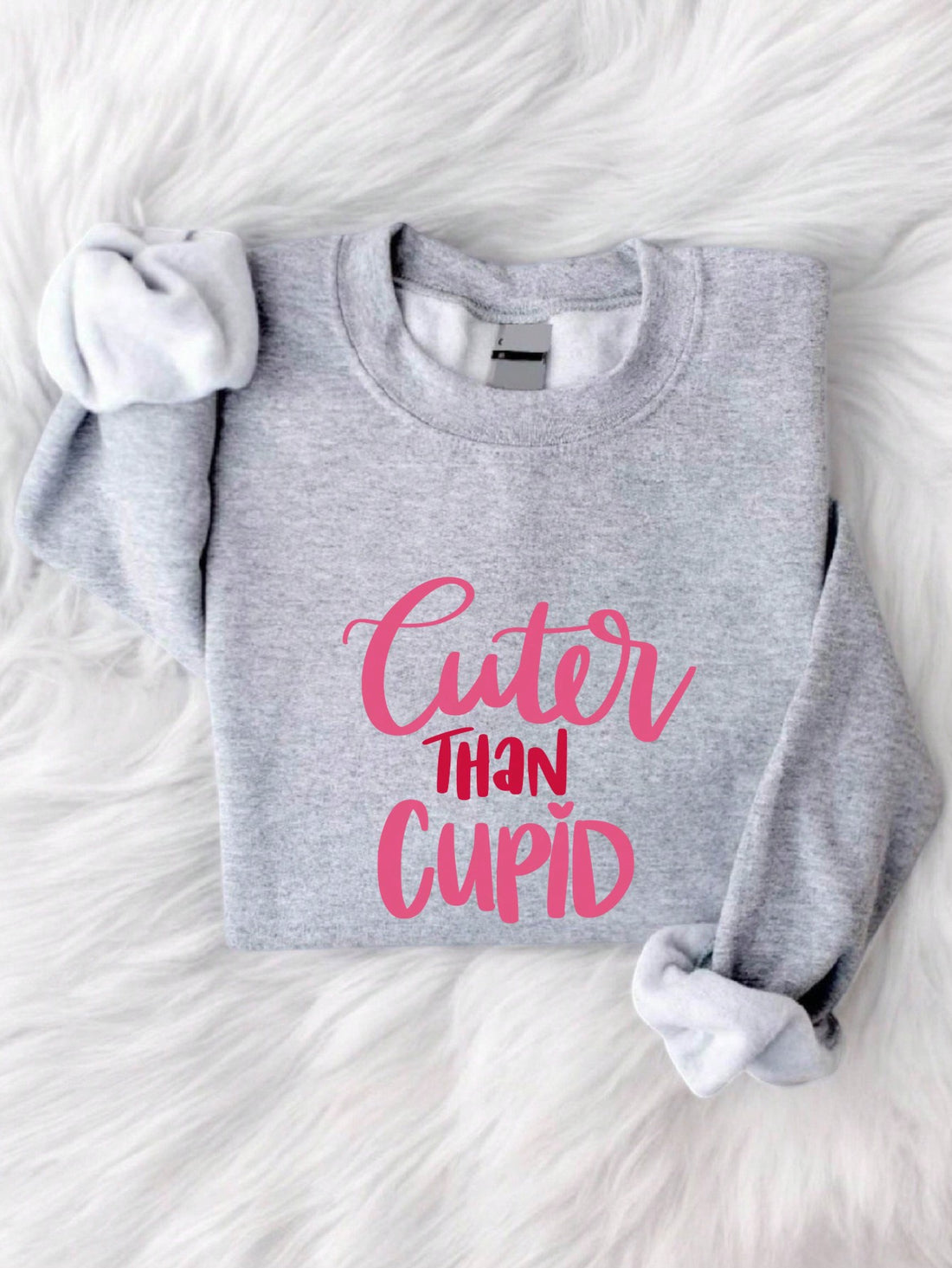 Spread some love and comfort this Valentine's Day with our Heartfelt Comfort sweatshirt! This cozy sweatshirt features a heartfelt message, "Cuter Than Cupid", perfect for your special someone. Stay warm and stylish while spreading some love and laughs.