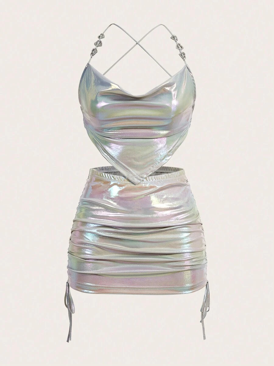 Elevate your style with this eye-catching holographic two-piece set. The sleek cami top features a shimmering holographic finish that catches light from every angle, while the drawstring side skirt offers a modern silhouette with adjustable fit. Perfect for festivals, nights out, or making a bold fashion statement. The reflective material creates a mesmerizing iridescent effect that stands out in any crowd. Mix and match with your favorite pieces or wear together for maximum impact. Comfortable, versatile, 