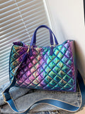 Catch the light and turn heads with this eye-catching holographic quilted top handle bag. The shimmering, iridescent finish shifts with every angle, making it the ultimate statement piece for anyone who loves bold style. Quilted detailing adds texture and dimension, while the sturdy top handle keeps your essentials secure and stylish. Whether you're heading to brunch, a night out, or just running errands, this bag brings that fun, futuristic vibe to any outfit. Compact yet spacious enough for your daily mus
