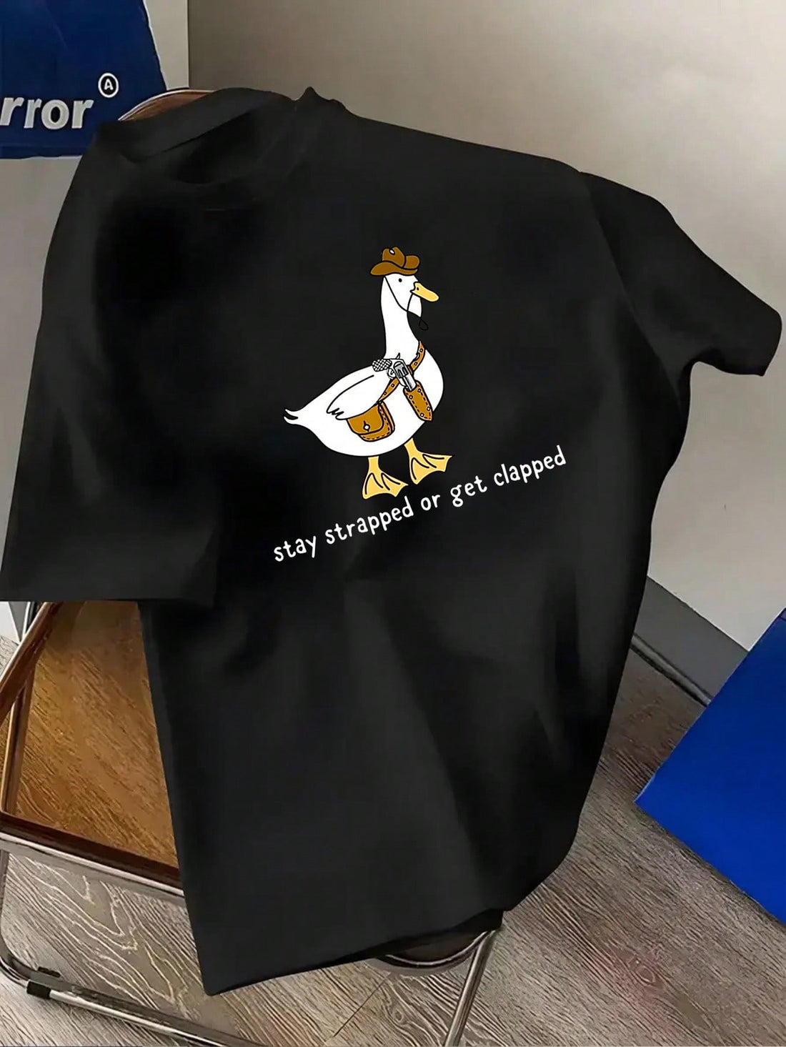 Saddle up with this playful Cowboy Duck Graphic T-Shirt designed just for big and tall men who like to keep it casual and cool. Featuring a cheeky "Stay Strapped or Get Clapped" slogan, this tee brings humor and attitude to your everyday wardrobe. Perfect for those who want to stand out with a fun twist on classic cowboy style.