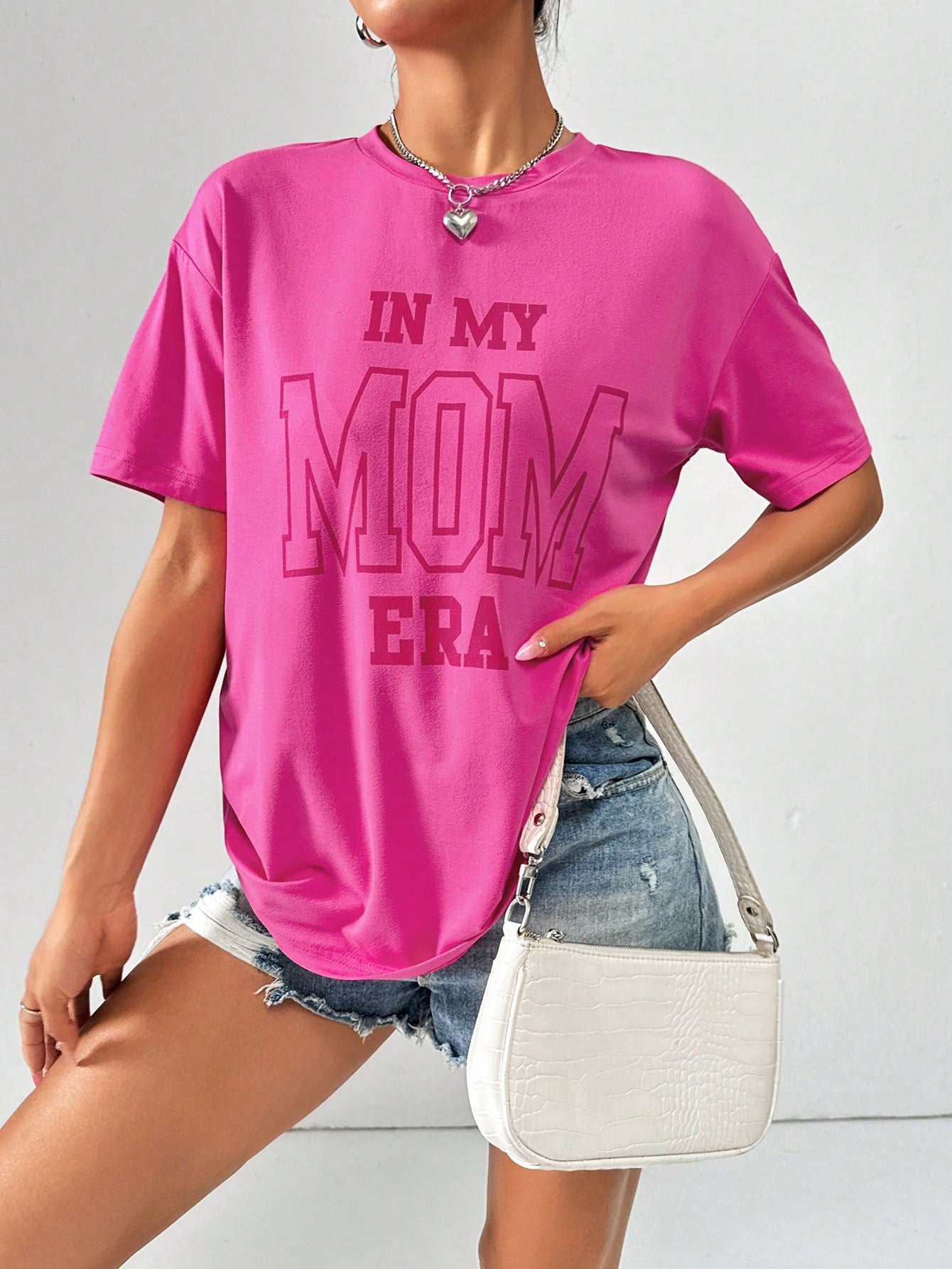 Rock your casual style with this IN MY MOM ERA graphic tee. Its loose-fit design makes it perfect for a laid-back summer look. Effortlessly stylish, this tee is a must-have for any wardrobe. Show off your unique personality with this fun and quirky shirt. (Go ahead, make your mom proud!)
